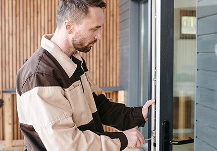 A man opening a door to a house.